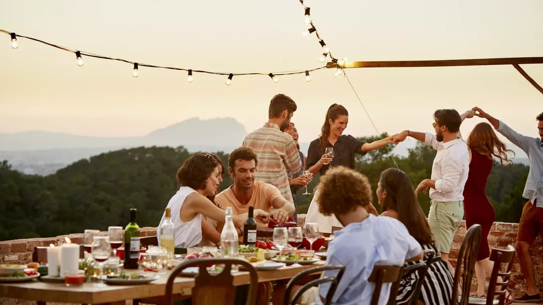 Spain Friends enjoying at patio during social gathering at sunset in Spain