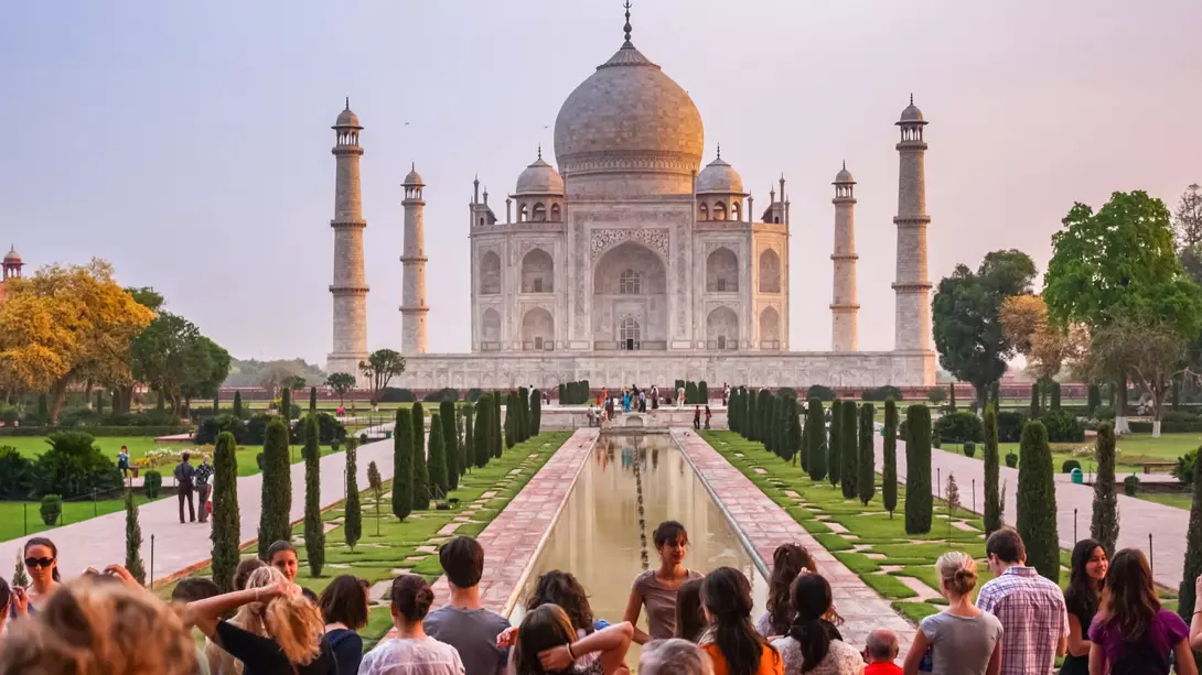 Taj Mahal in Agra, India Group of tourists visit the landmark Taj Mahal in Agra, India