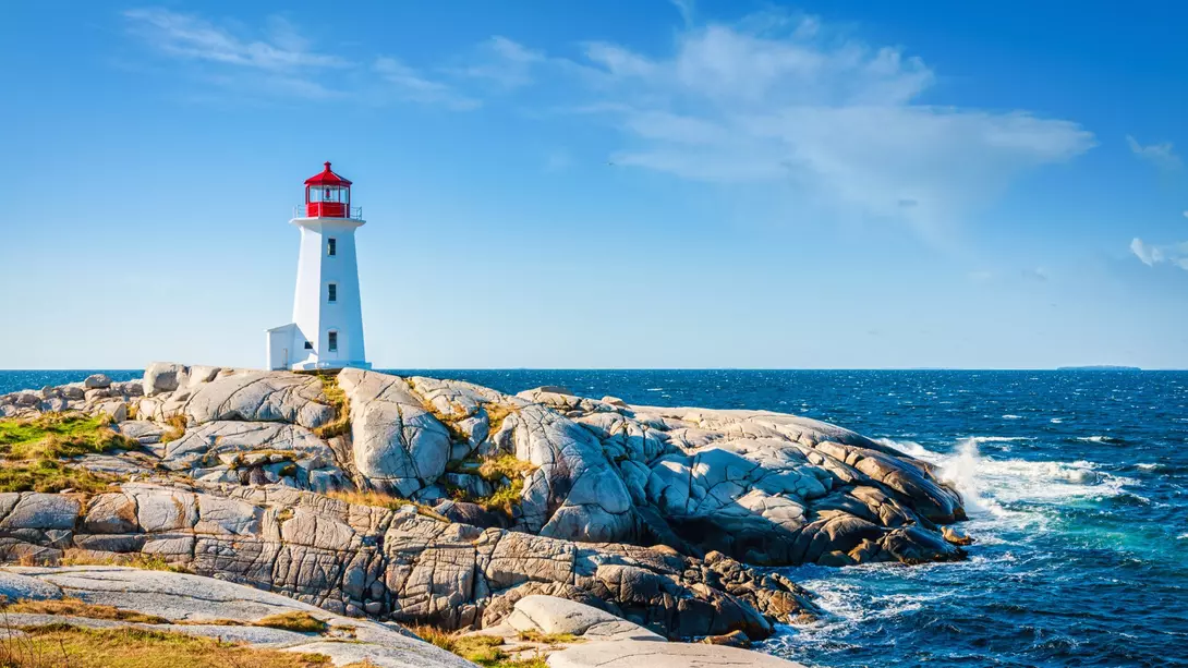 Peggy's Cove Lighthouse, Halifax Peggy's Cove Lighthouse under blue summer sky on the coast of the Atlantic Ocean.