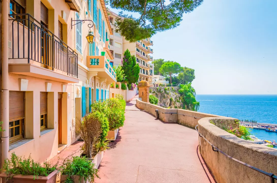 Typical walking street with colorful houses along the seaside of Monaco