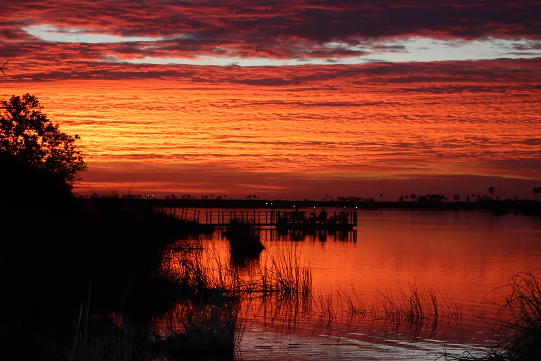 Sunset over river at wildlife reserve