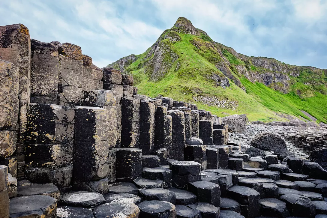 Beautiful Giants Causeway Volcanic Landscape with famous Hexagonal Basalt Columns under dramatic skyscape