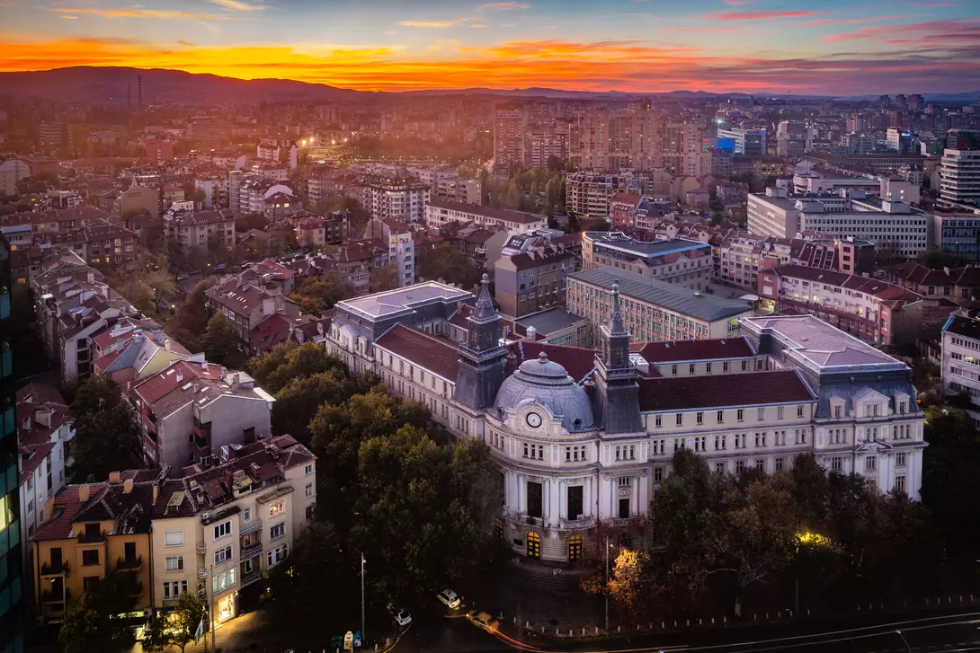 Panoramic high angle view above Western city of Sofia, Bulgaria, Eastern Europe during sunset back light into the sky