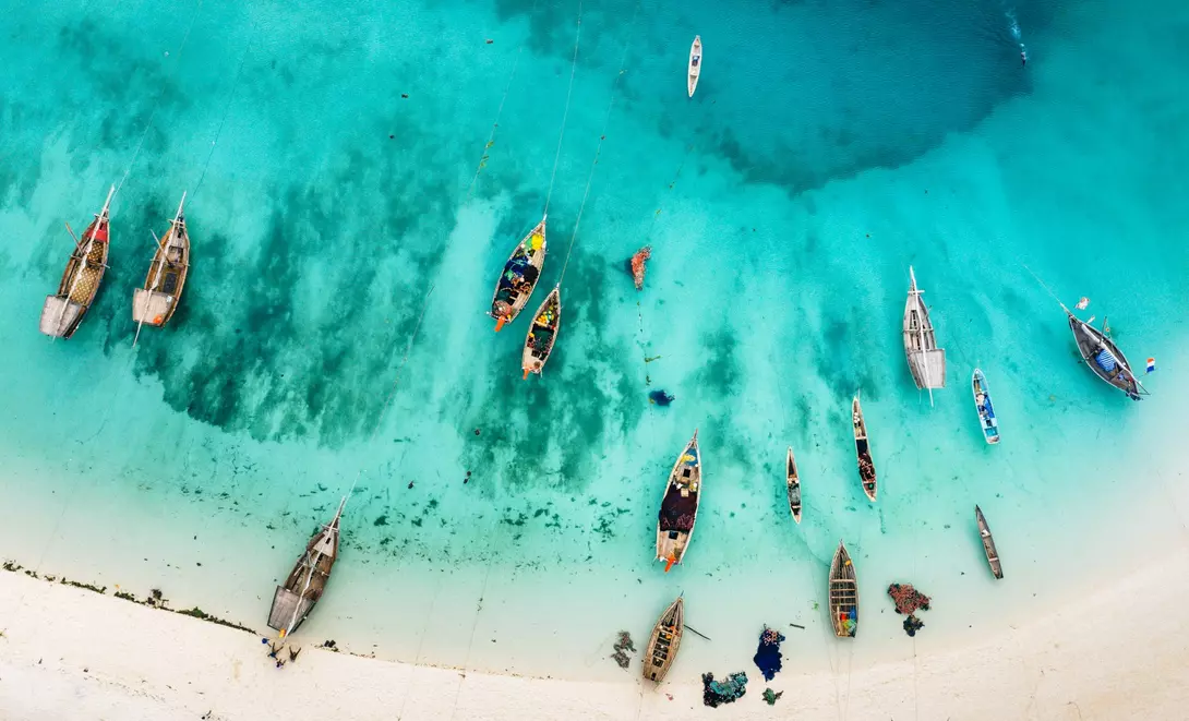 Aerial photos of boats and stunning blue waters of beach