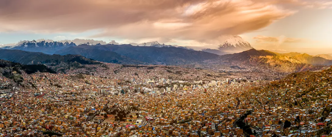 Panoramic view of La Paz, Bolivia, during sunset with Illimani Mountain rising in the background