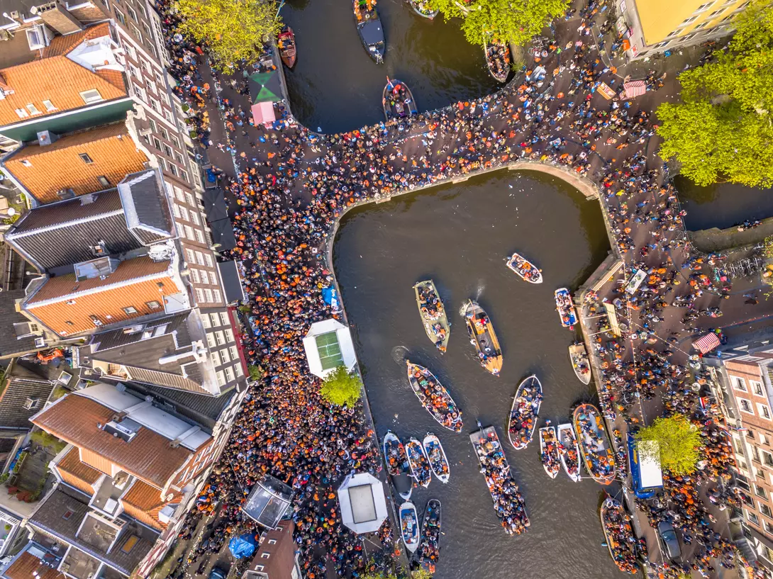 Canal boat parade on Koningsdag Kings day festivities in Amsterdam. Birthday of the king