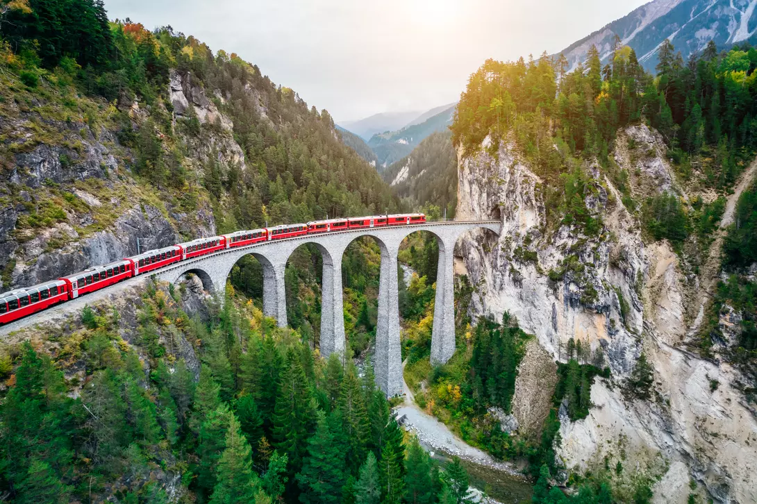 Train crossing Landwasser Viaduct on raethian railway in Filisur – Albula, Graubunden, Switzerland 