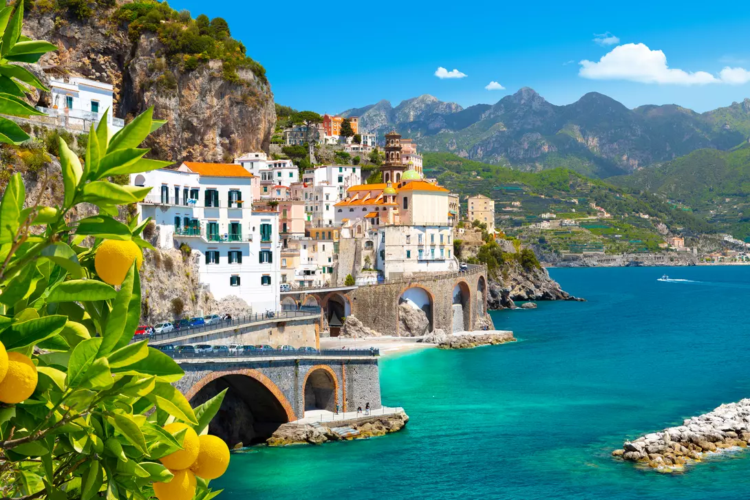 Beautiful view of Amalfi on the Mediterranean coast with lemons in the foreground
