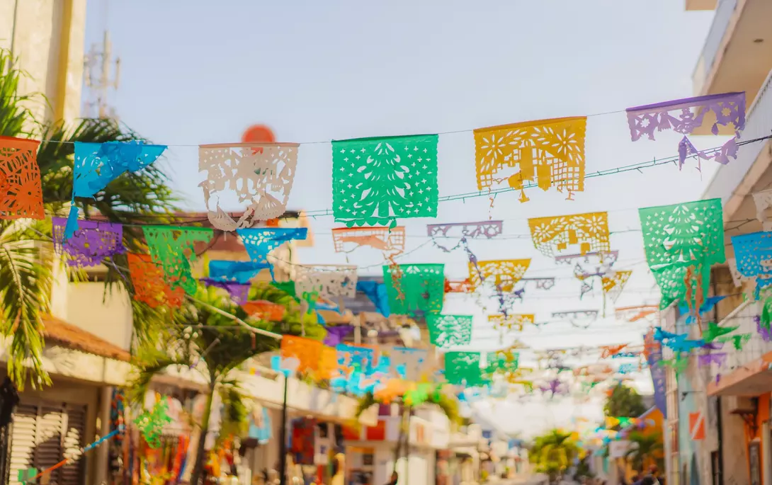 Colourful flags are waving on a shopping street in Mexico