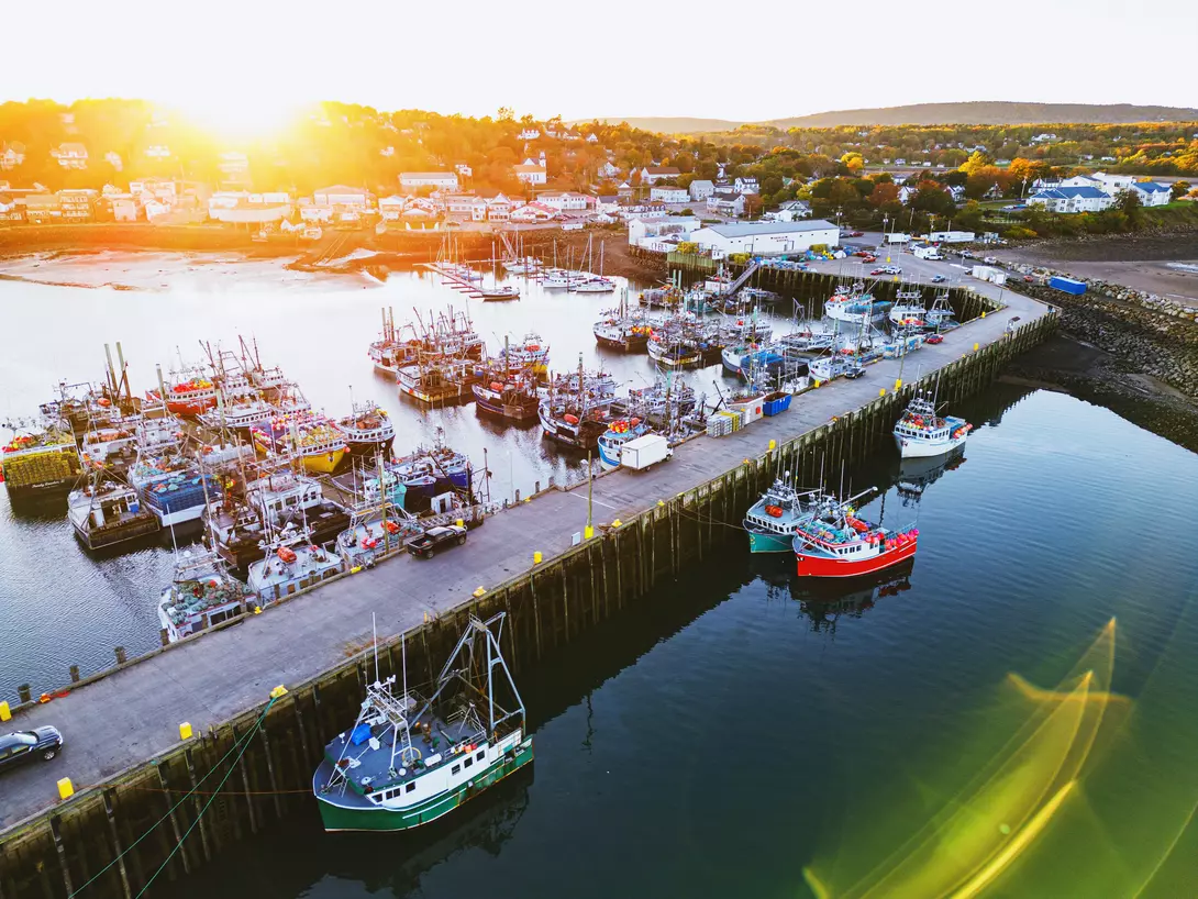 Aerial drone view of a small town fishing wharf just before sunset.