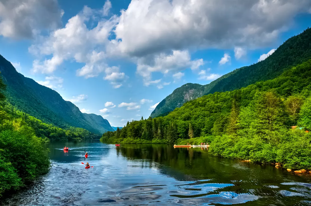 People rafting Jacques Cartier river on a perfect sunny summer day, Quebec, Canada