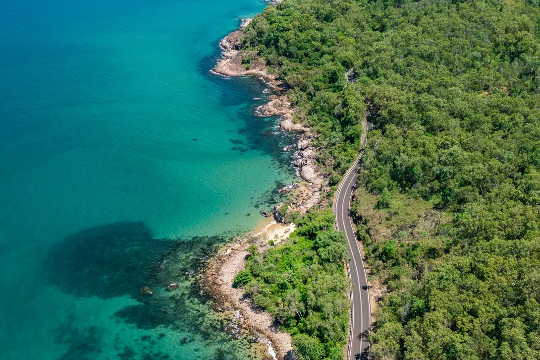 Aerial view of the Captain Cook Highway where the rainforest meets the reef in tropical Far North Queensland, Australia