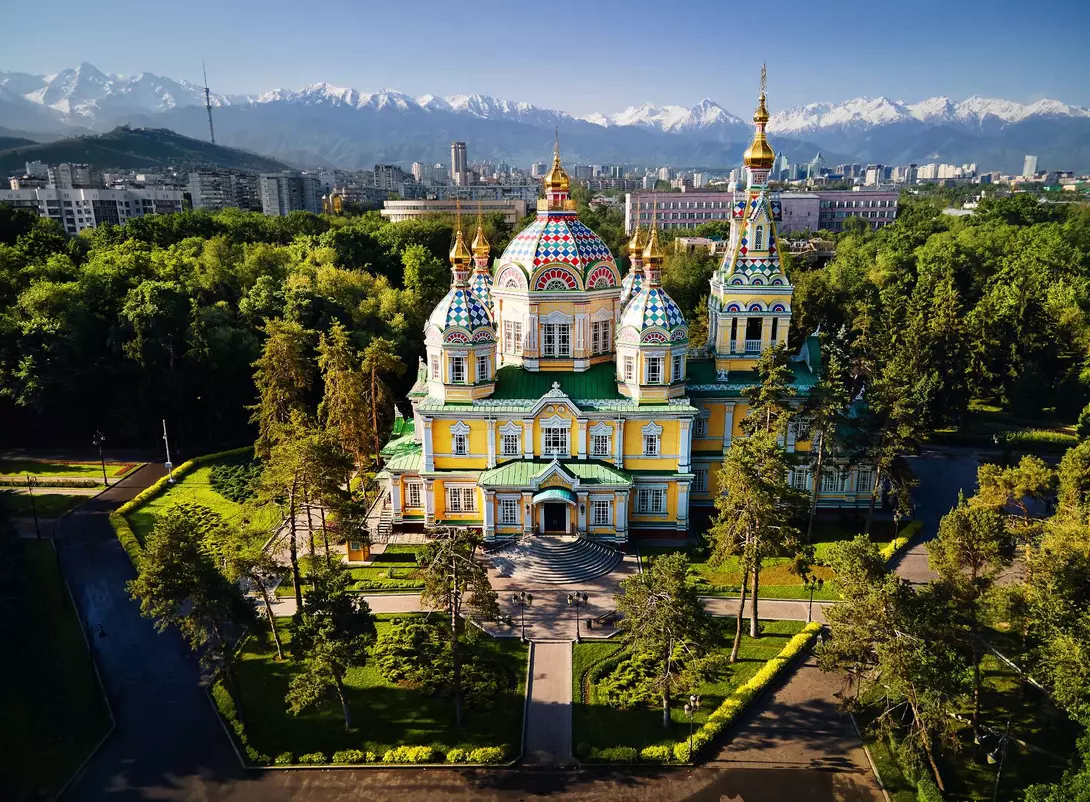 Zenkov Cathedral Aerial view of the Zenkov Cathedral in Panfilov Park against blue sky and and snowy mountains in Almaty city, Kazakhstan