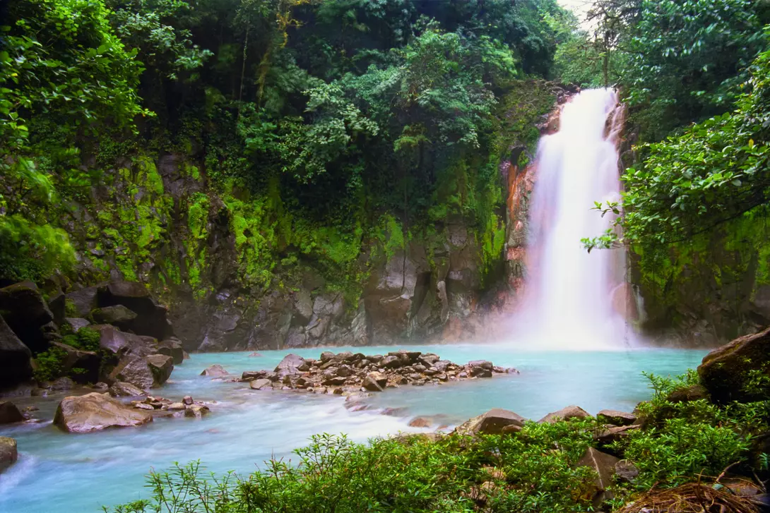 A secluded waterfall in a tropical rainforest. This is the Celeste Waterfalls in Costa Rica (Catarata Celeste).