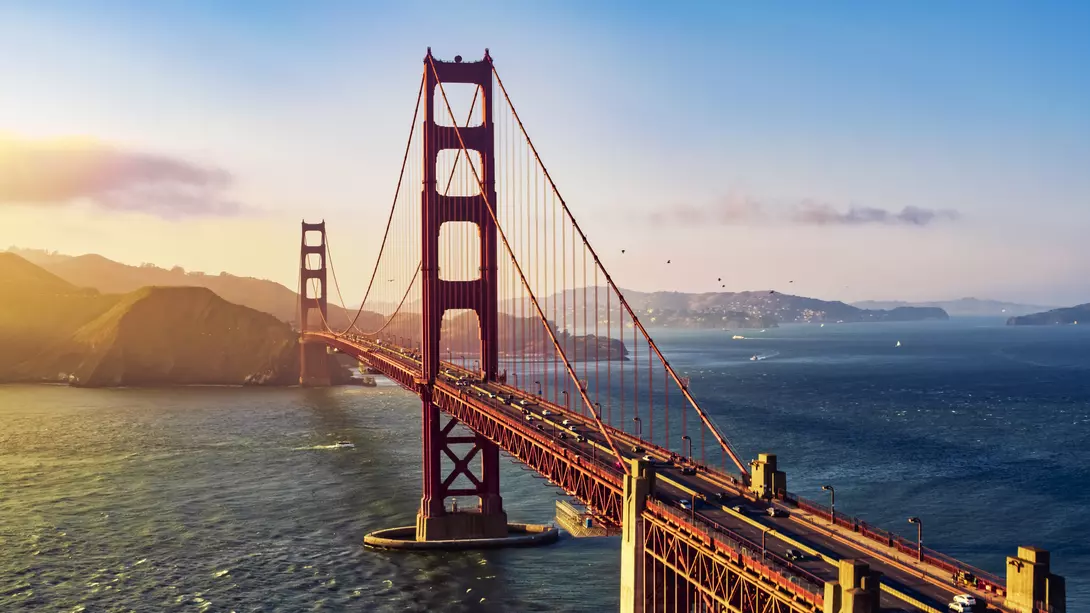 Aerial view of traffic moving on the bridge during sunset