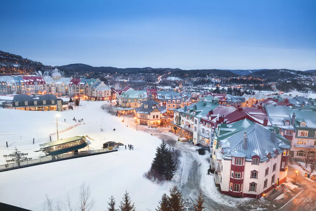 Ski lifts in the snowy Mont Tremblant village and mountainscape