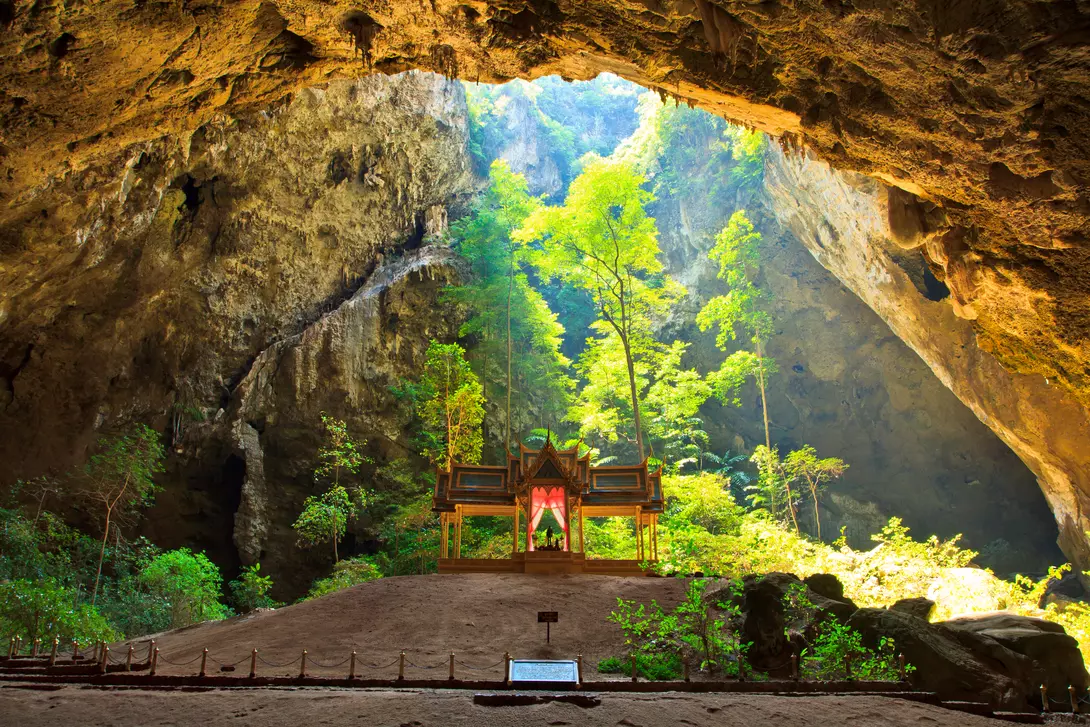 Sunlight shines down through Phraya Nakorn cave hole on pavillion of the king, Sam Roi Yot National Park