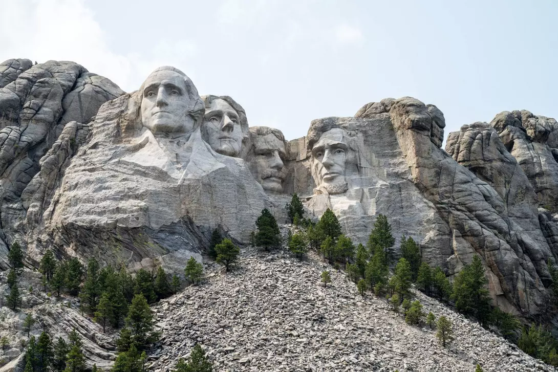 Close up view of Mount Rushmore under a blue sky
