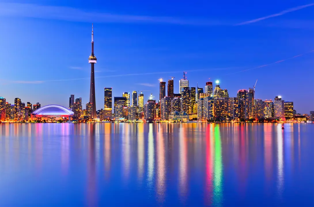 The city skyline at twilight reflecting in lake ontario