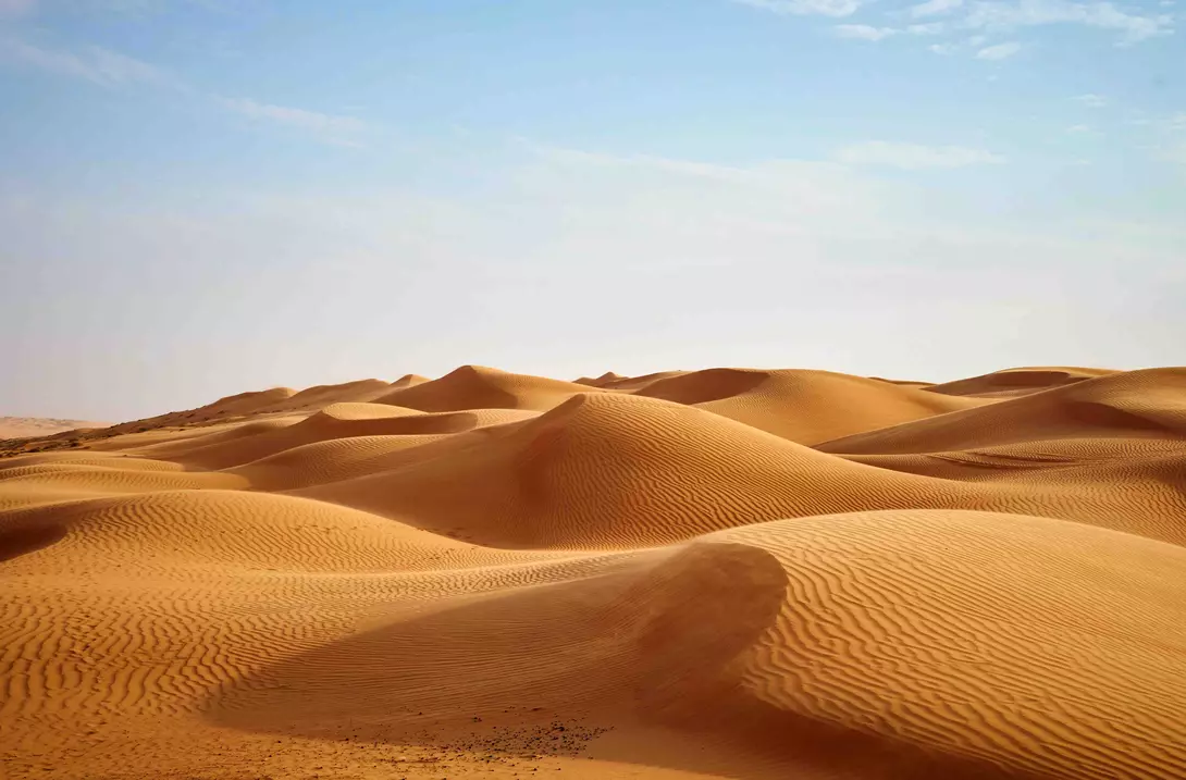 Wind blowing on the desert sand dunes of Oman