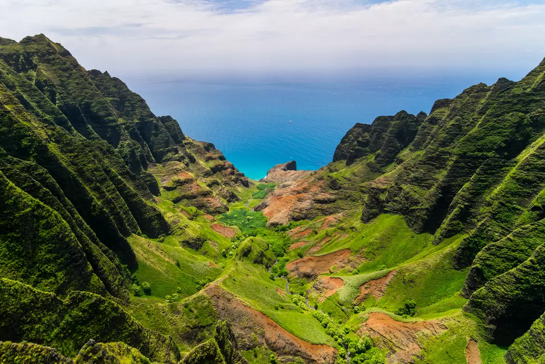 Aerial landscape view of cliffs and green valley over the pacific ocean