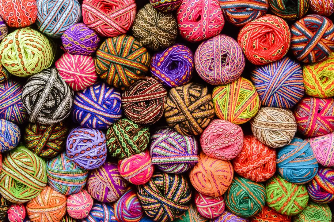A large variety of colorful traditonal balls ribbons in market in Cusco, Peru