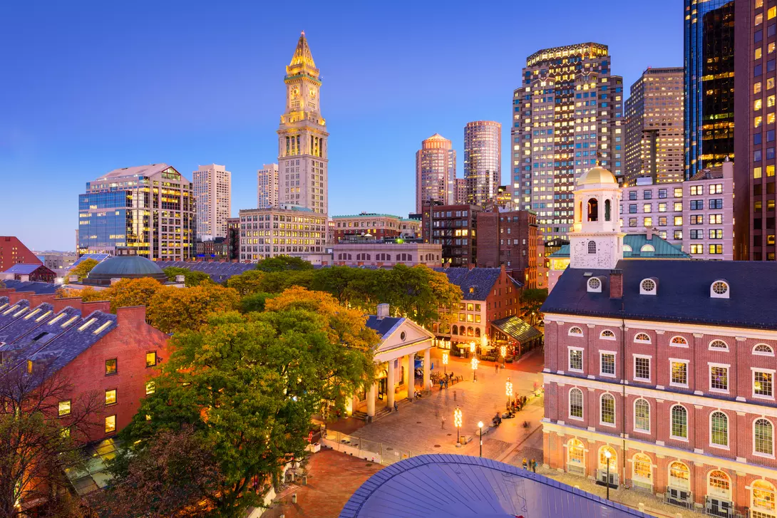 Downtown cityscape at night with the Quincy Market front and center