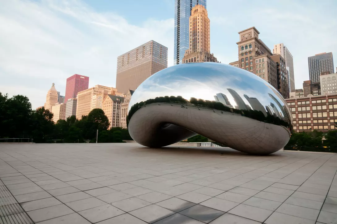 The Bean and Chicago skyline early in the day in Millennium Park just after sunrise
