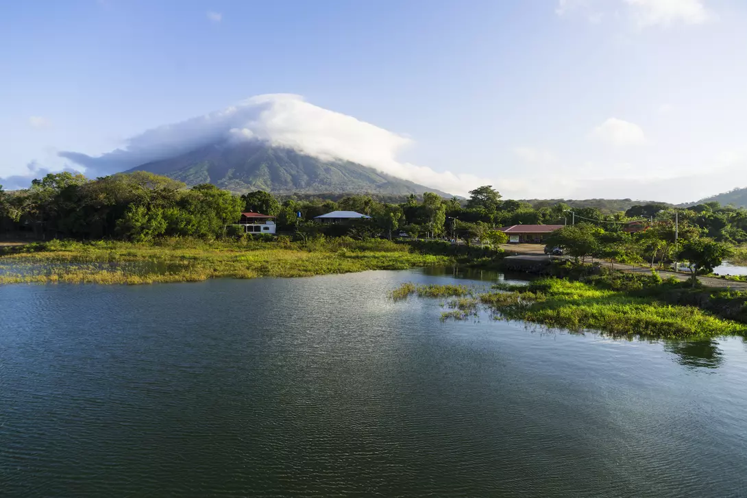 Morning view from Lake Nicaragua to island Ometepe and volcano Concepcion with white clouds on it