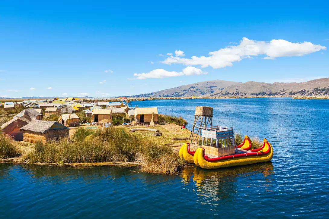 Uros fishing boat floating on Titicaca Lake near Puno, Peru