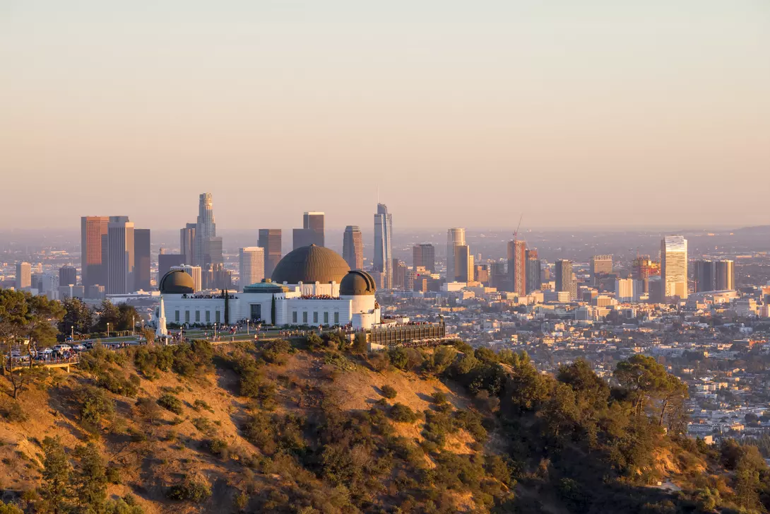 Downtown skyline behind Griffith Observatory at sunset
