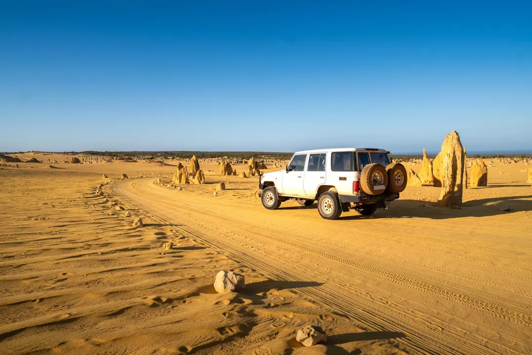 Four-wheel-drive car in the Pinnacles Desert, Nambung National Park, Western Australia.