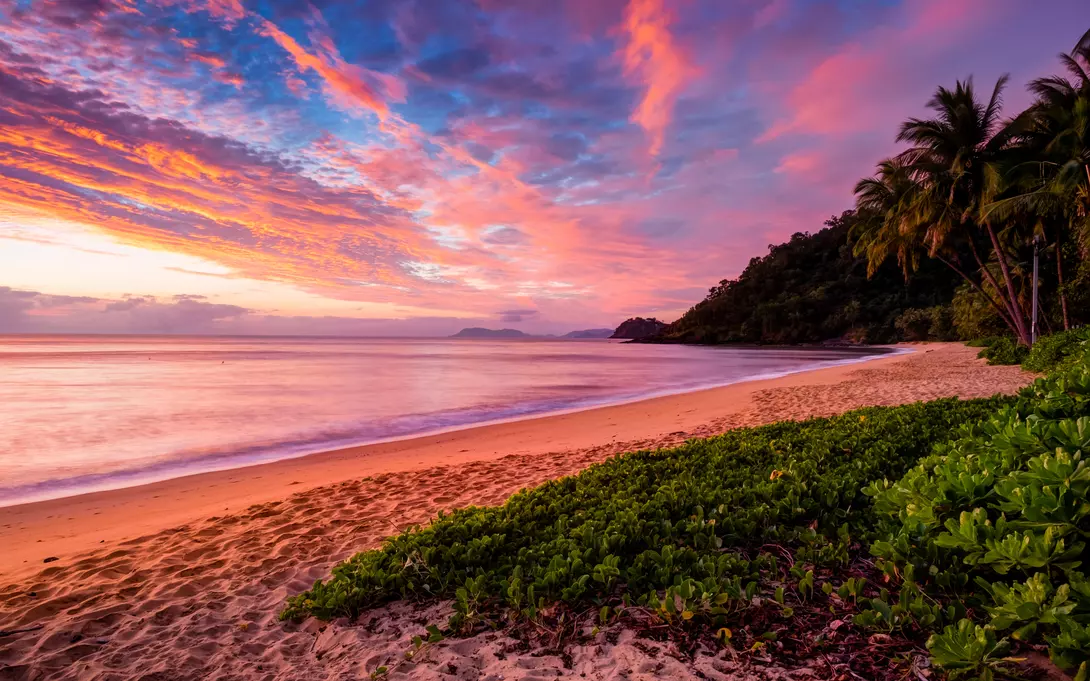 Admire the painted sunset skies of Cairns