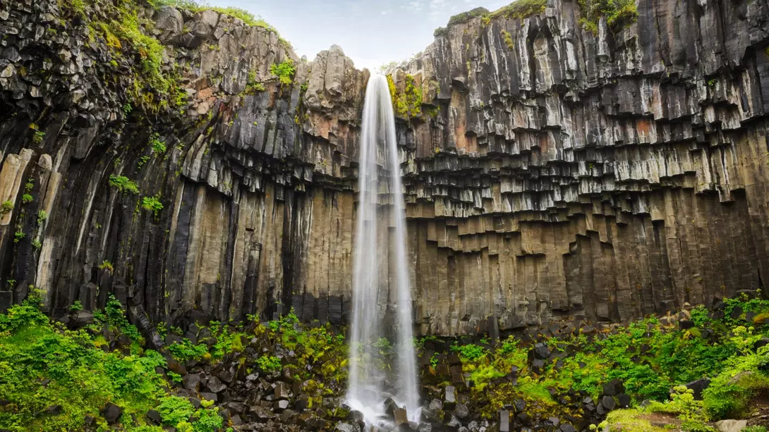 Svartifoss Waterfall in Iceland near Vatnajokull glacier, famous for its wide basalt stone wall.