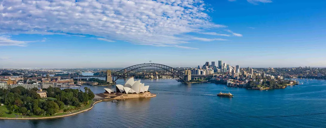 aerial view of a beautiful harbour with opera house, bridge, and ciy