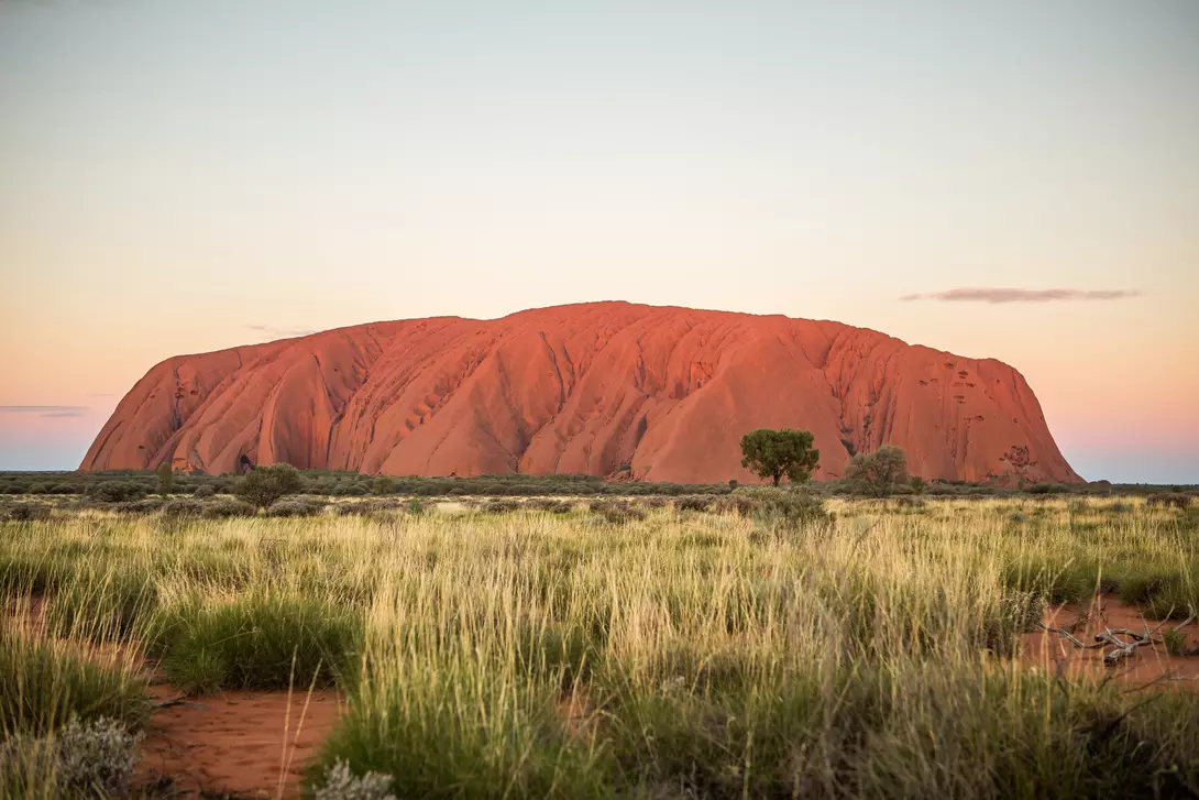 red rock monolith at sunset in outback