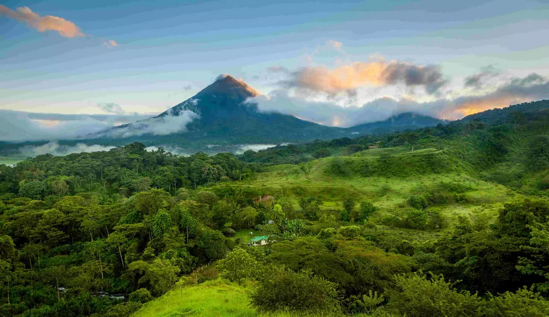 arenal volcano with clouds and green forests in Costa Rica