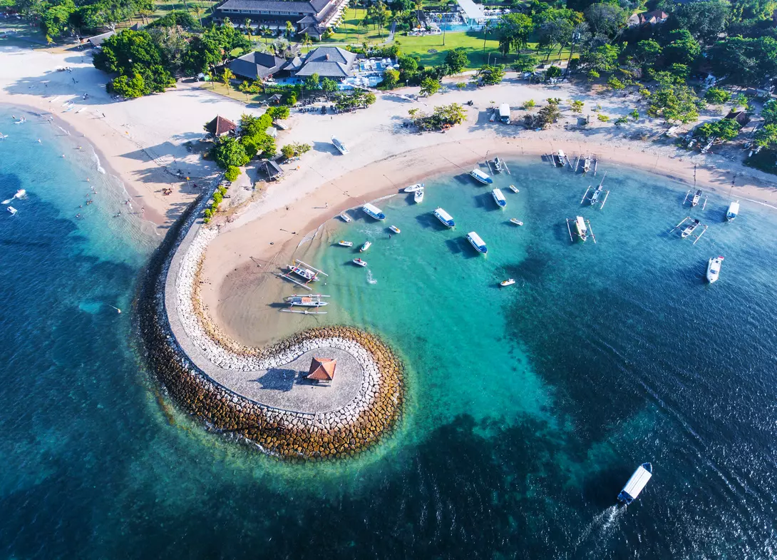 Bali Nusa Dua coast with a figurative breakwater aerial view.