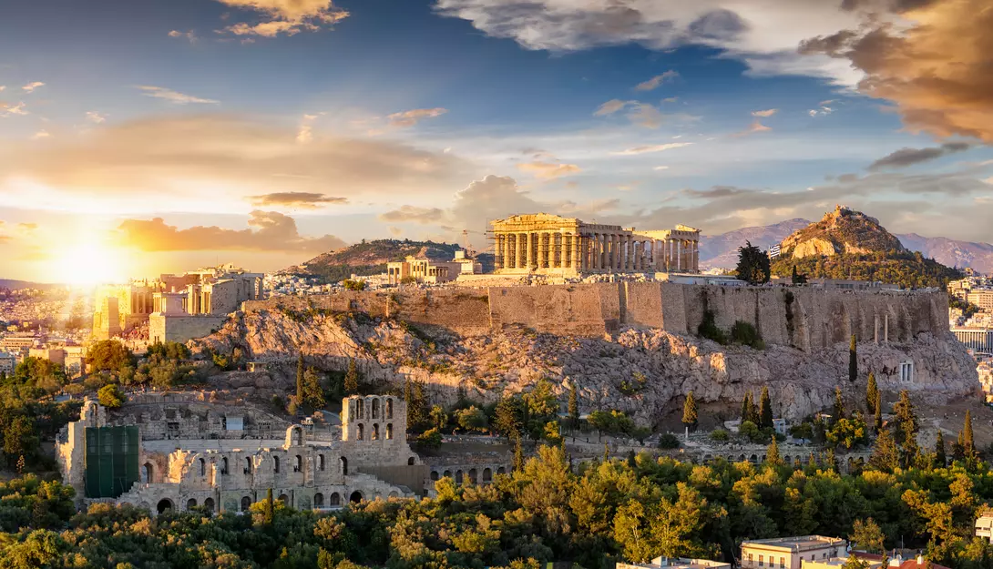 The Acropolis of Athens with the Parthenon Temple on top of the hill during a summer sunset.