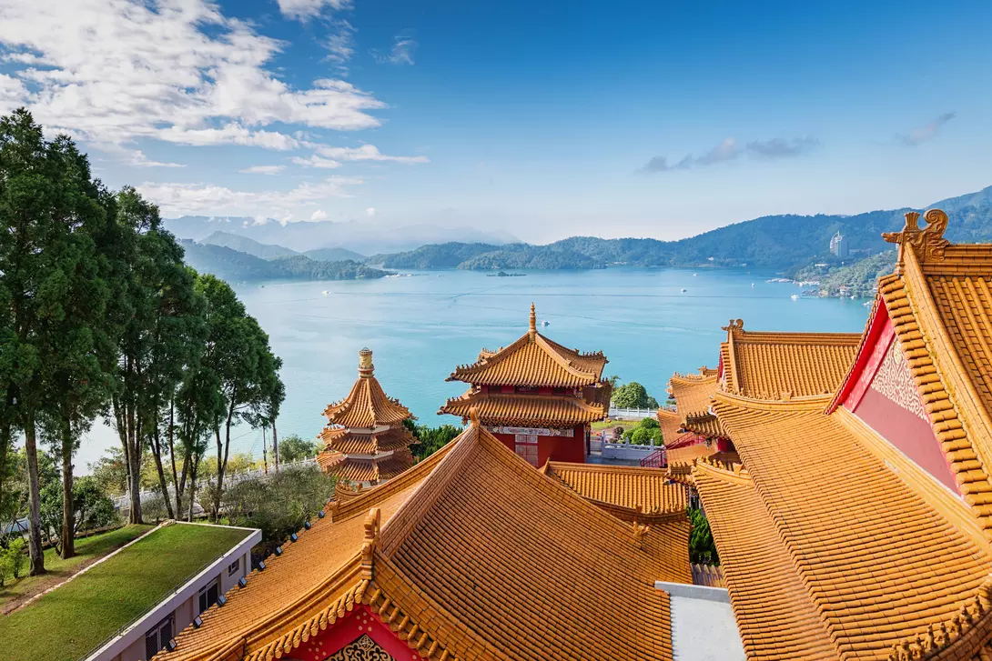 Beautiful view towards the famous Sun Moon Lake View under blue sunny sky over Wen Wu Temple Rooftops.