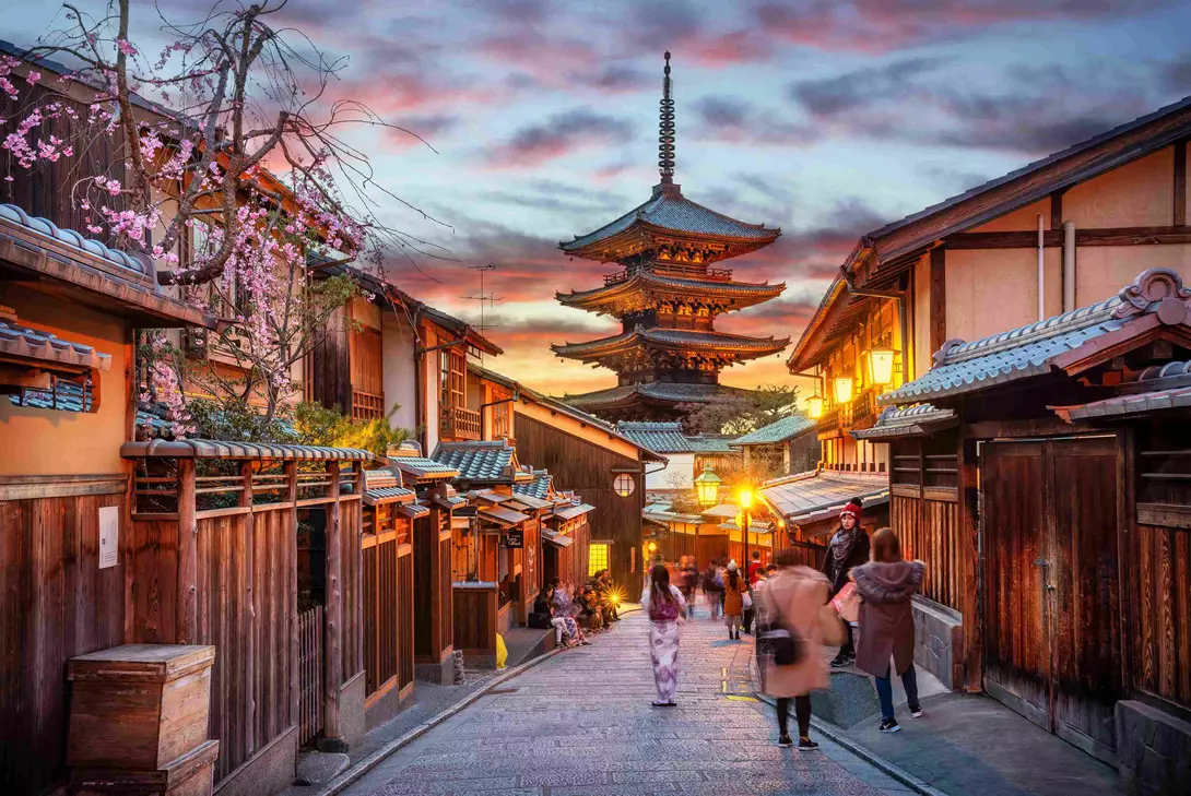 Yasaka Pagoda and Sannen Zaka Street, Kyoto, Japan. Tourists wander down the narrow streets of the Higashiyama District neighbourhood in Kyoto, Japan
