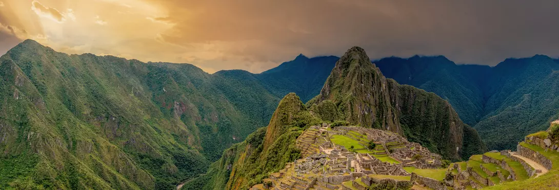 Machu Picchu is a 15th-century Inca citadel located in the Eastern Cordillera of southern Peru on a 2,430-meter (7,970 ft) mountain ridge. It is located in the Machupicchu District within Urubamba Province above the Sacred Valley, which is 80 kilometers (50 mi) northwest of Cusco. The Urubamba River flows past it, cutting through the Cordillera and creating a canyon with a tropical mountain climate. Most recent archaeologists believe that Machu Picchu was constructed as an estate for the Inca emperor Pachac