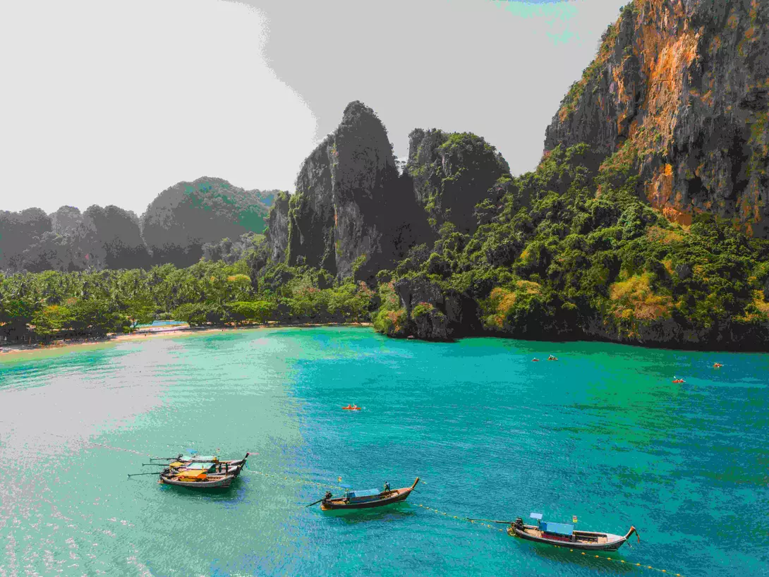 Scenic aerial view of sea kayaking near idyllic Railey beach in Thailand