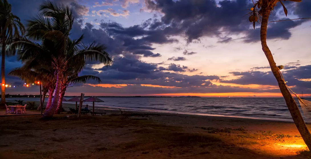 A beautiful beach setting comes to life as the sun goes down.