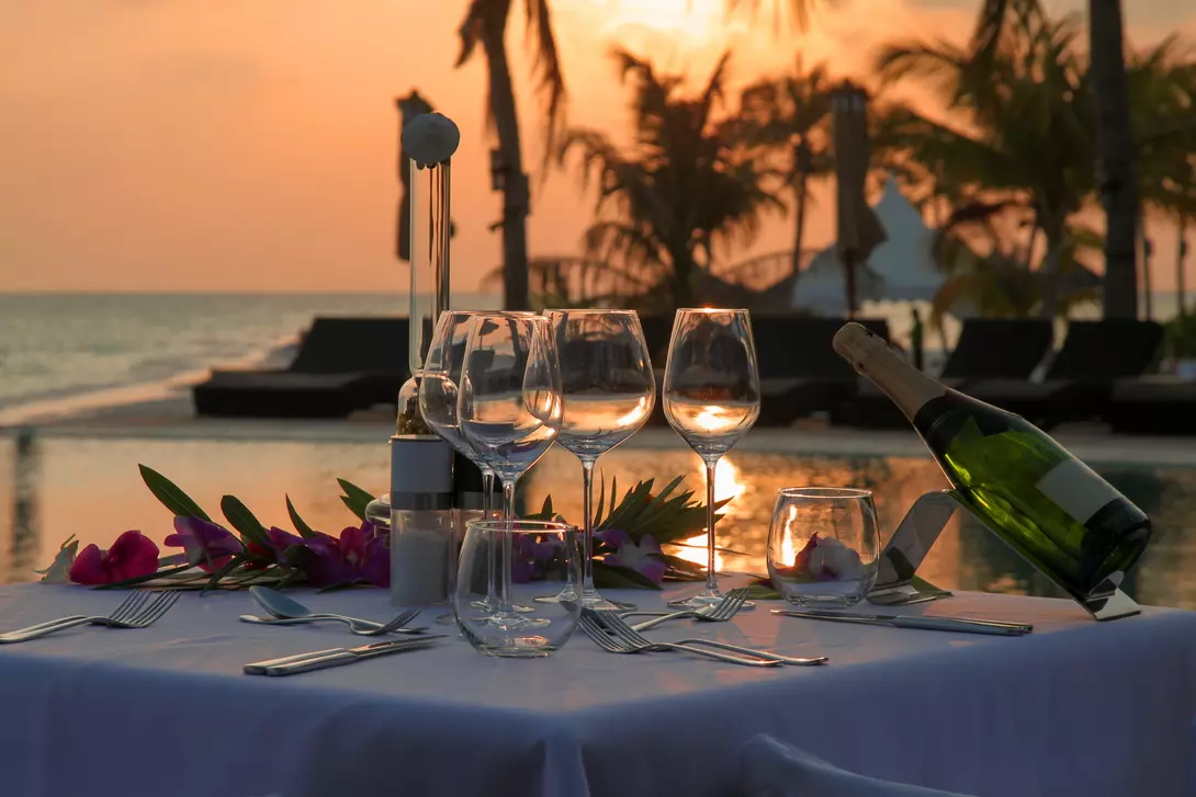 Beach Dinner by the Infinity Pool in Sunset Scenery.