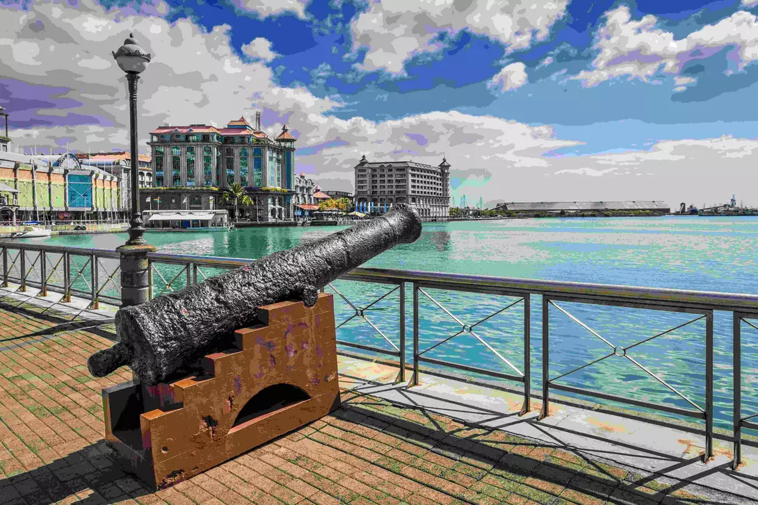 Old cannon on the promenade at Caudan Waterfront, Port Louis, Mauritius.