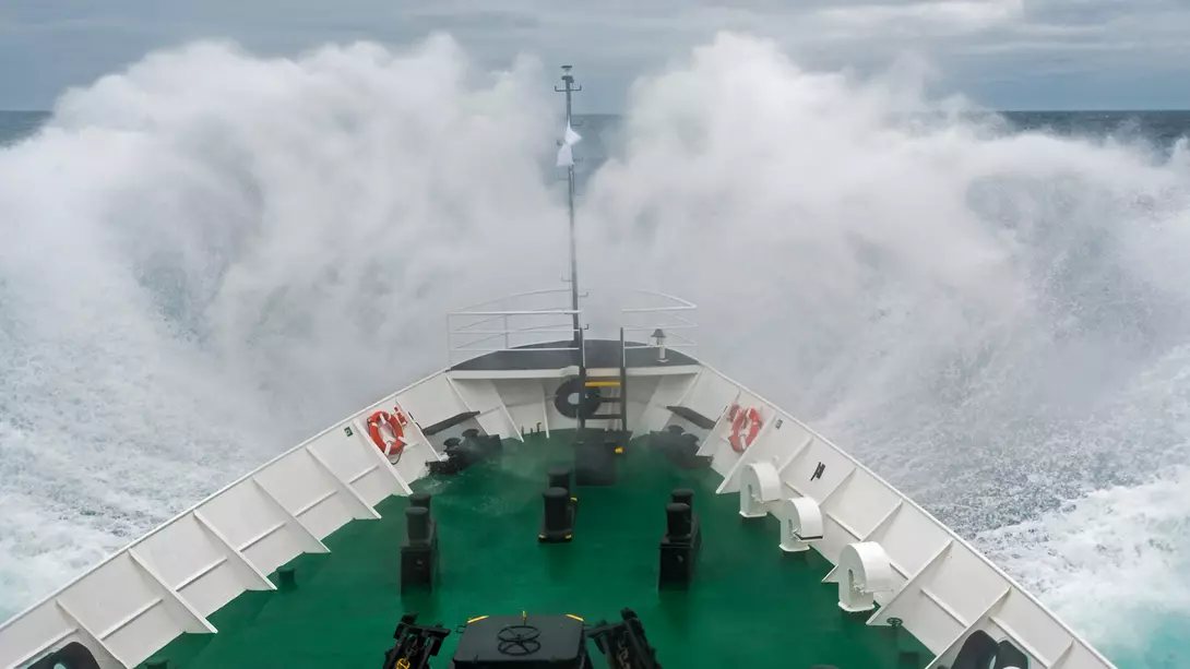 An expedition vessel cuts through the choppy waters of the Drake Passage.