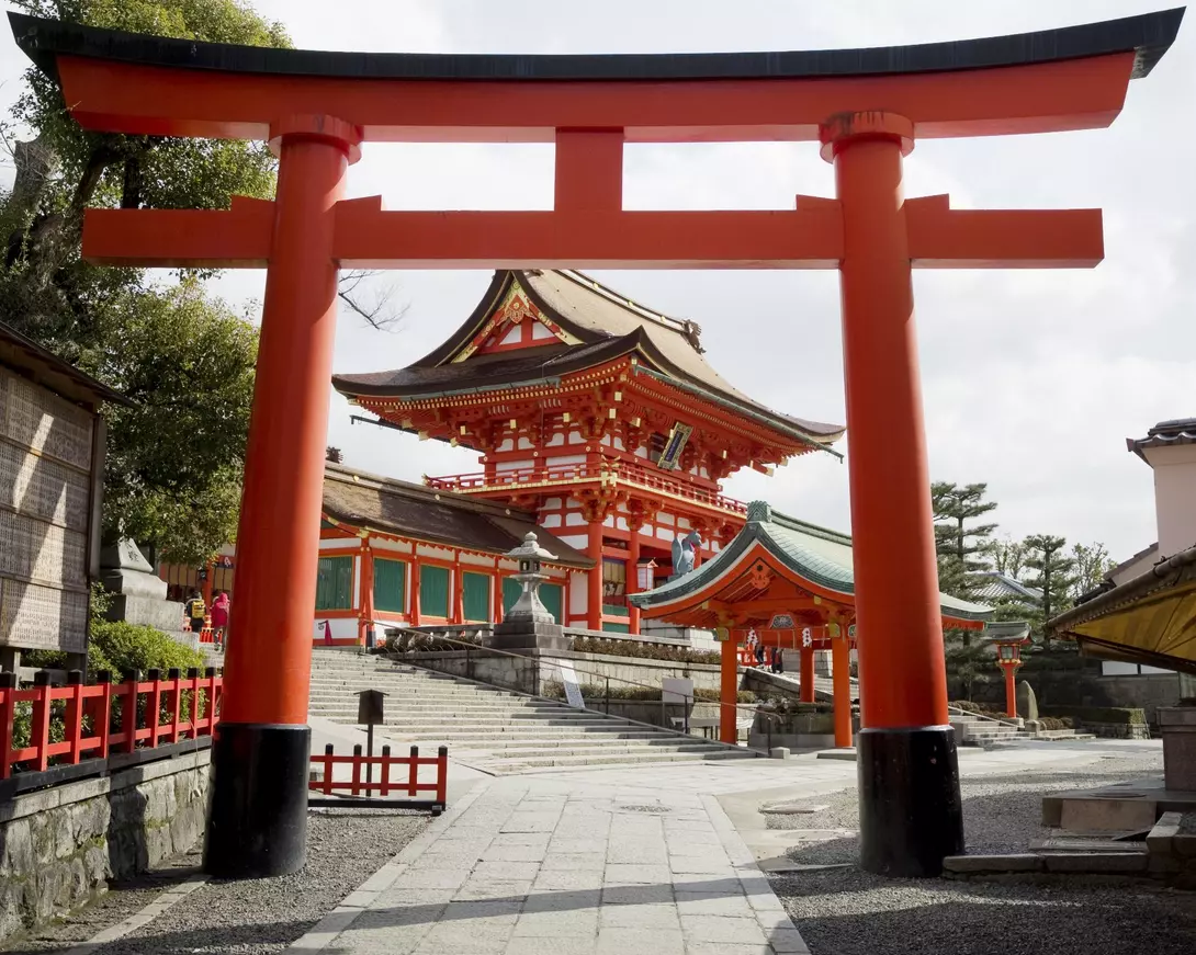A huge orange "torii" gate marks the main entrance to the premises of the Fushimi Inari shinto shrine.
