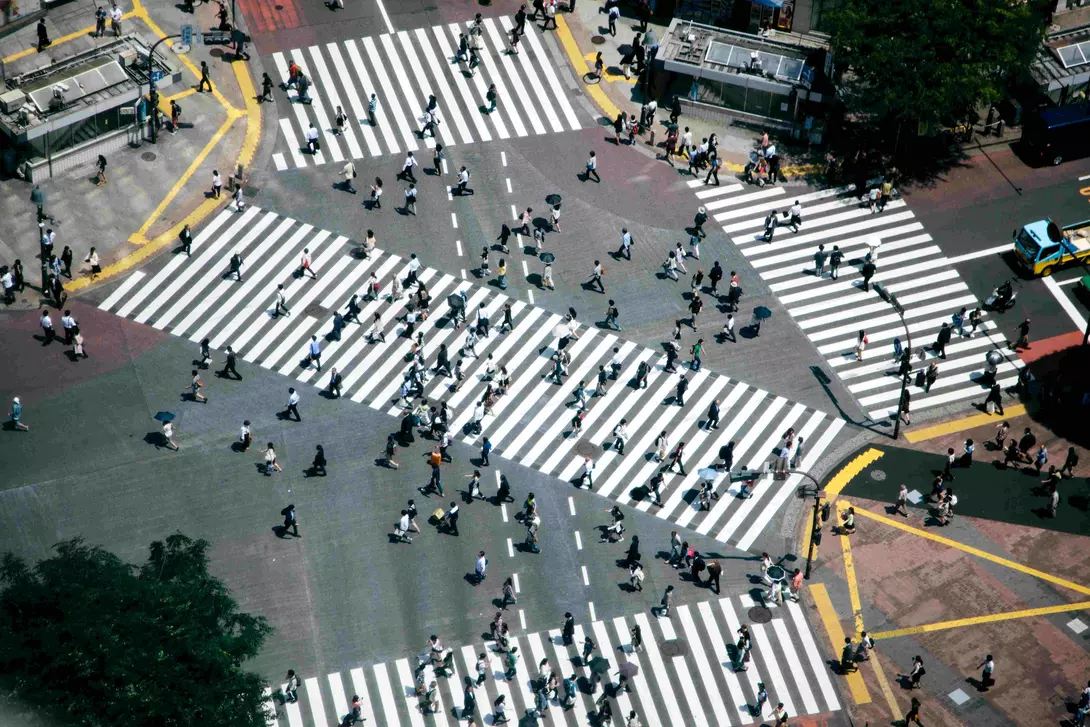 Shibuya crossing, pedestrians crossing the road, aerial view. Spring, daylight