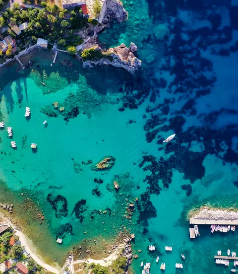 Aerial view of the coastline shot from the air, showing deep blue colours of the Mediterranean Sea.